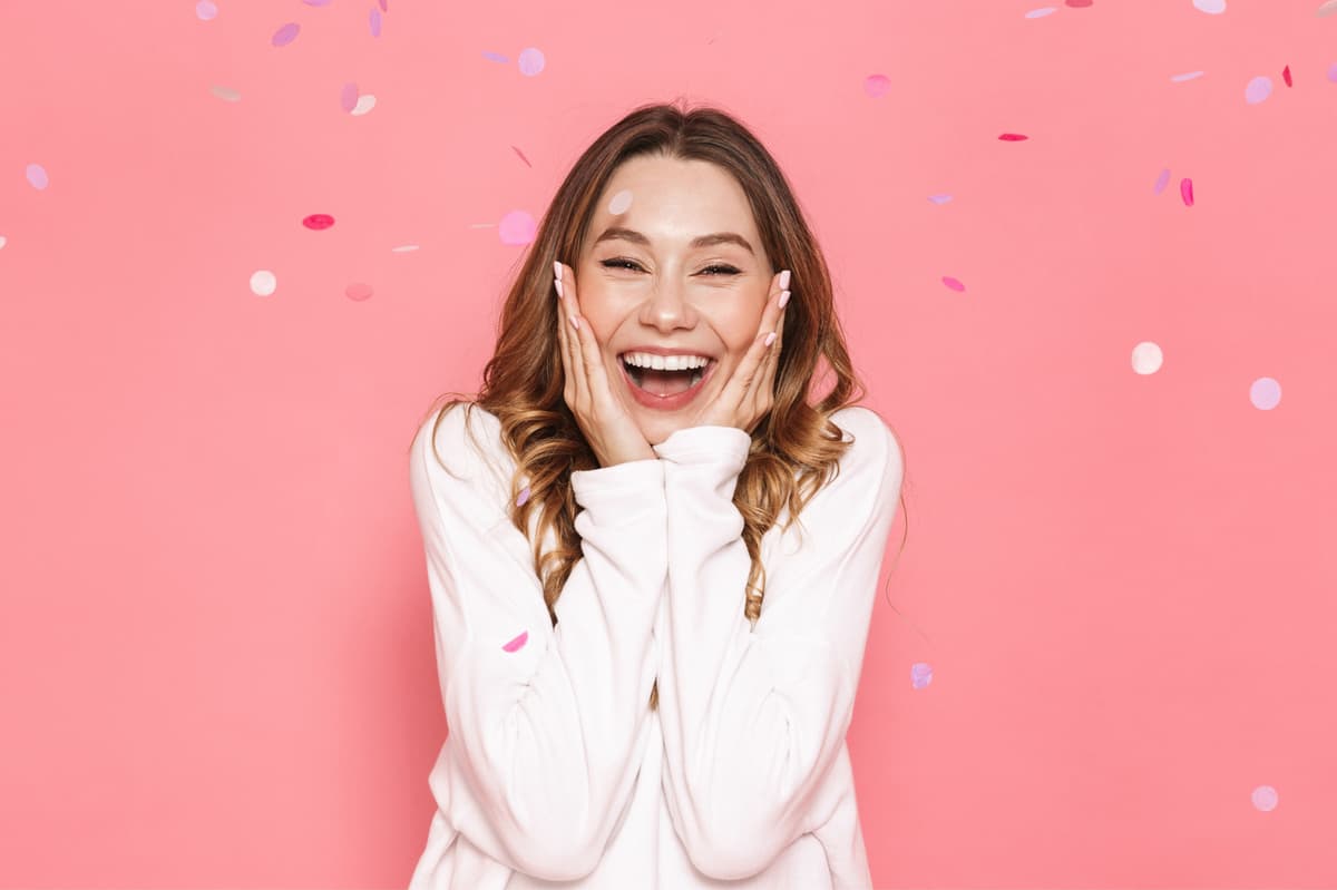 Excited woman celebrating with confetti