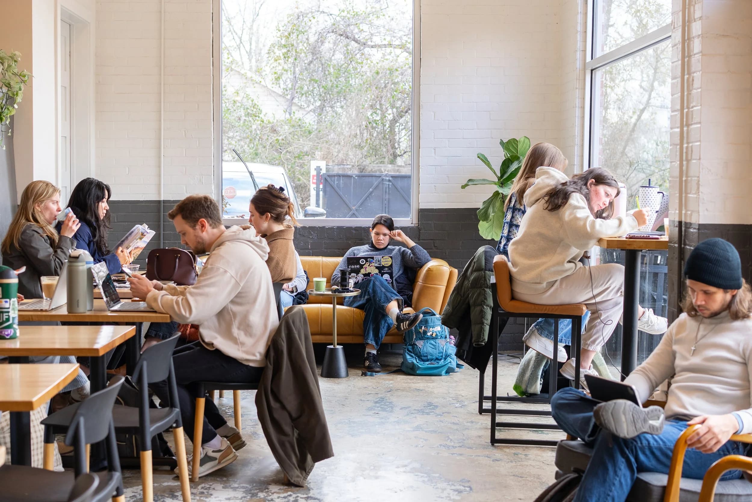 Inside Native Coffee Co. — customers enjoying coffee in a bright, airy seating area with large windows and modern decor