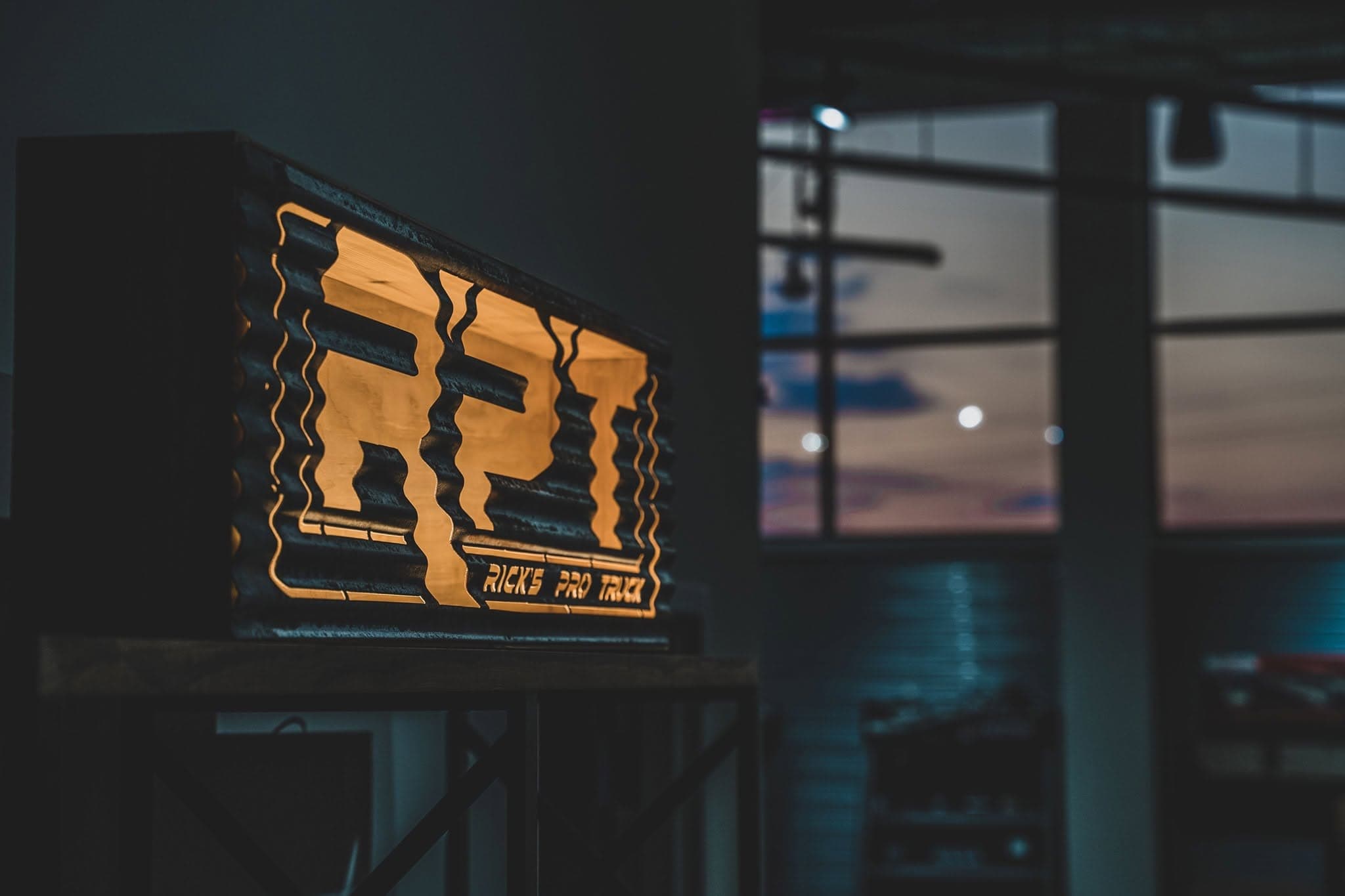 Rick's Pro Truck lit RPT sign inside the Pearl showroom